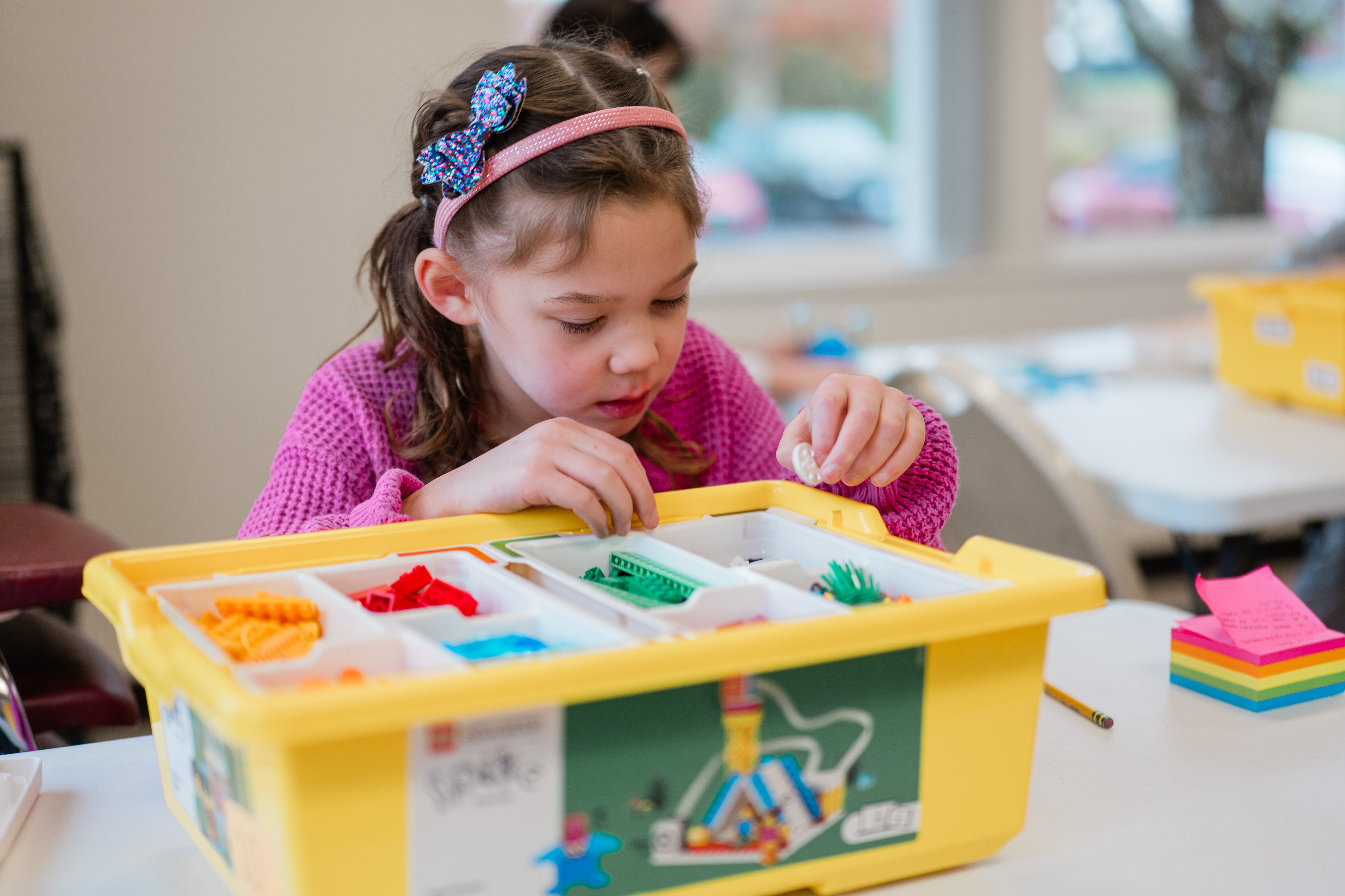 Girl building with LEGO